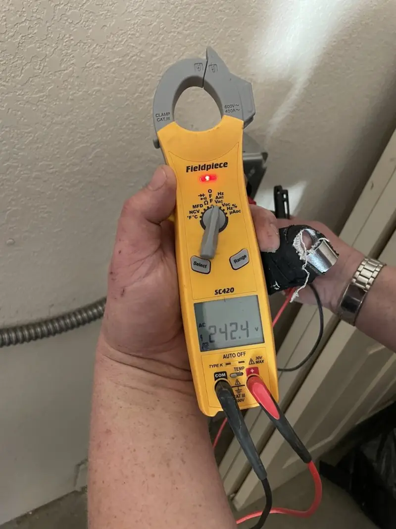 Voltage testing with clamp meter during Recessed Lighting Installation in Easley